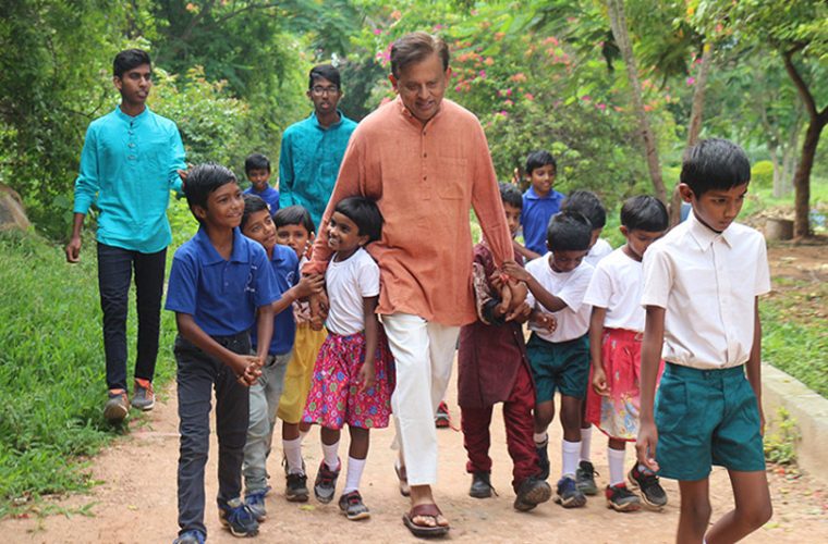 Dr. George walking outside with students