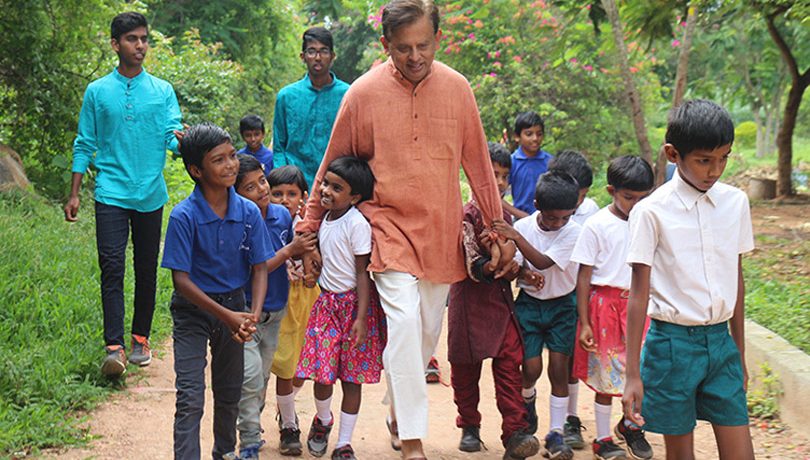 Dr. George walking outside with students