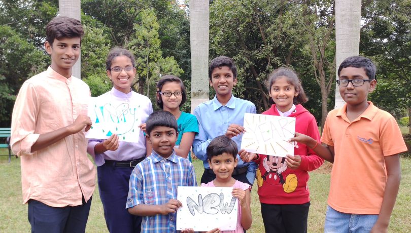 Children holding a "Happy New Year" sign