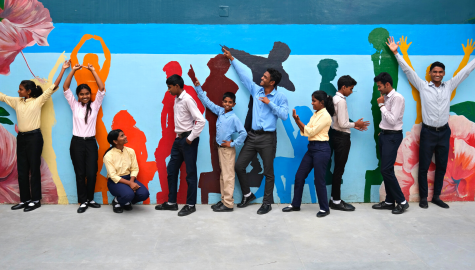 children posing by wall