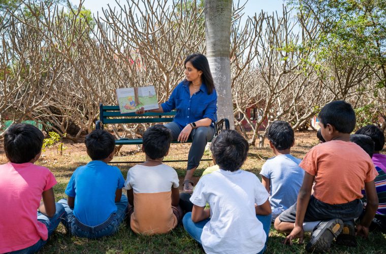 Woman reading to children